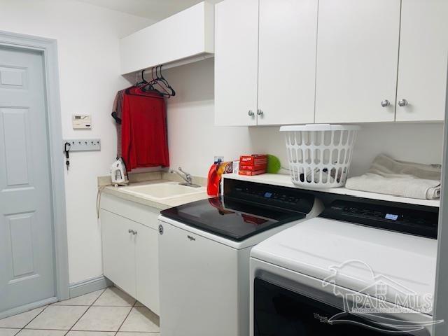 1358 Windsor Park Rd, Gulf Breeze, FL 32563 - washroom featuring washer and dryer, cabinet space, and light tile patterned flooring