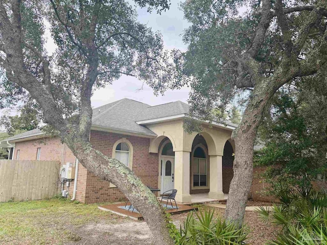 1358 Windsor Park Rd, Gulf Breeze, FL 32563 - view of front of house featuring brick siding, a shingled roof, and covered porch