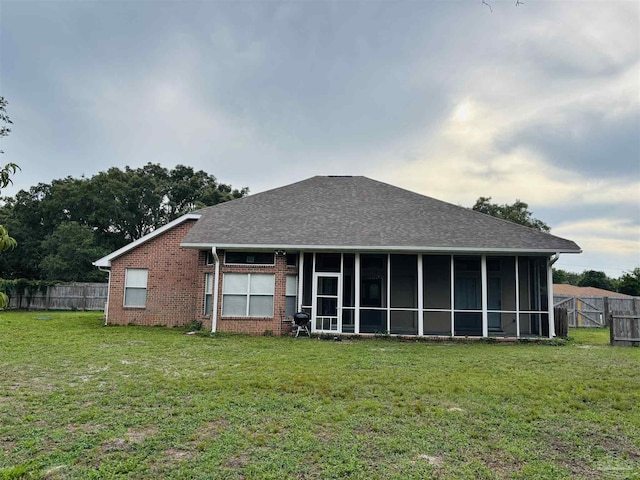 1358 Windsor Park Rd, Gulf Breeze, FL 32563 - rear view of house with roof with shingles, brick siding, and a sunroom
