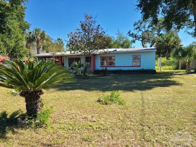 ranch-style home with a front lawn