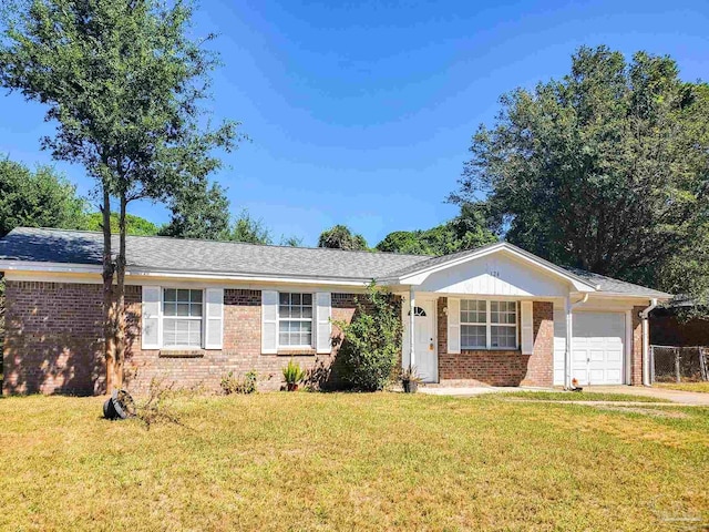 ranch-style house with a garage and a front lawn