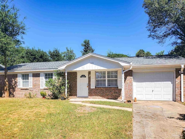 single story home with a garage and a front lawn