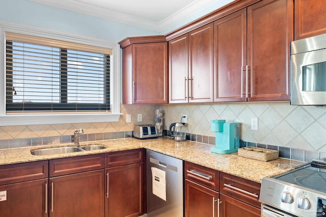 kitchen featuring decorative backsplash, light stone counters, appliances with stainless steel finishes, crown molding, and sink