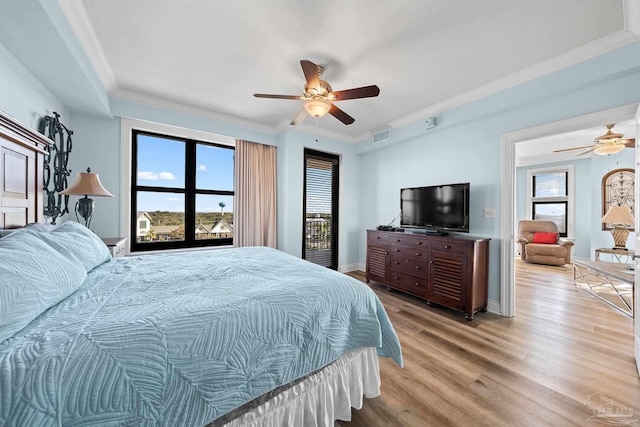 bedroom with light hardwood / wood-style floors, ornamental molding, and ceiling fan