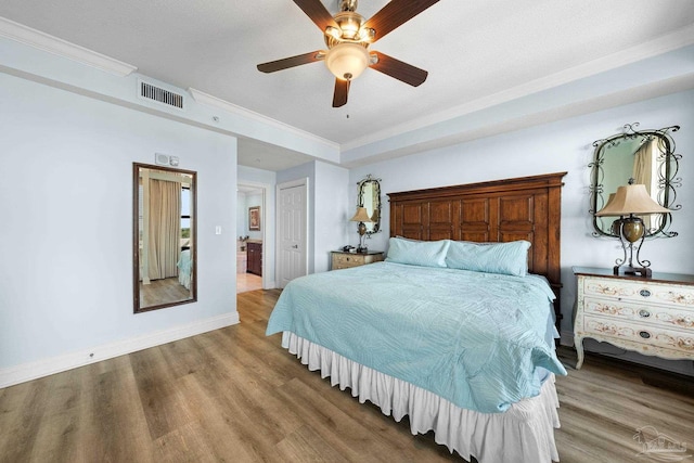 bedroom with a closet, ceiling fan, crown molding, and hardwood / wood-style floors