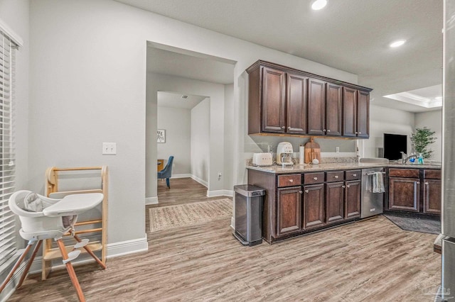 kitchen with dishwasher, light wood-style floors, baseboards, dark brown cabinetry, and recessed lighting
