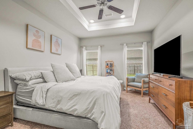 bedroom with light carpet, crown molding, a tray ceiling, a ceiling fan, and recessed lighting