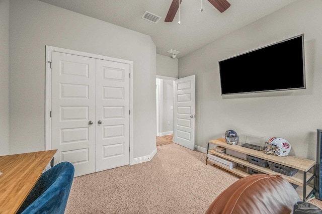 interior space with carpet floors, ceiling fan, and baseboards