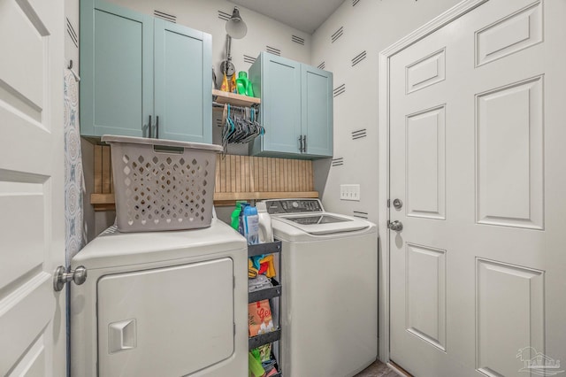 laundry area featuring cabinet space and separate washer and dryer