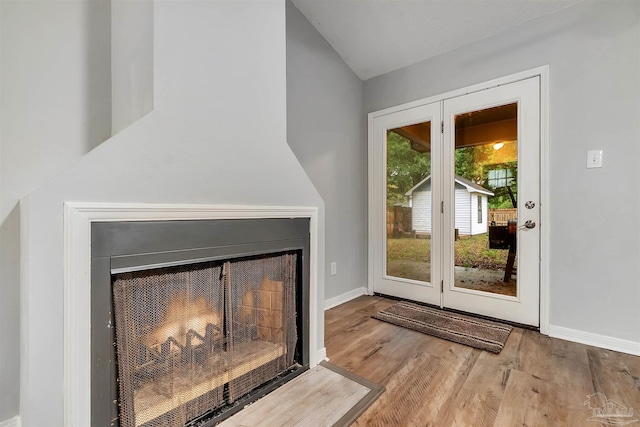 6205 E Forest Pines Dr, Pensacola, FL 32526 - doorway to outside with vaulted ceiling, wood finished floors, and a fireplace