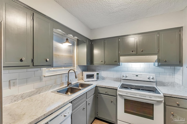 6205 E Forest Pines Dr, Pensacola, FL 32526 - kitchen with white appliances, under cabinet range hood, a textured ceiling, gray cabinets, and tasteful backsplash