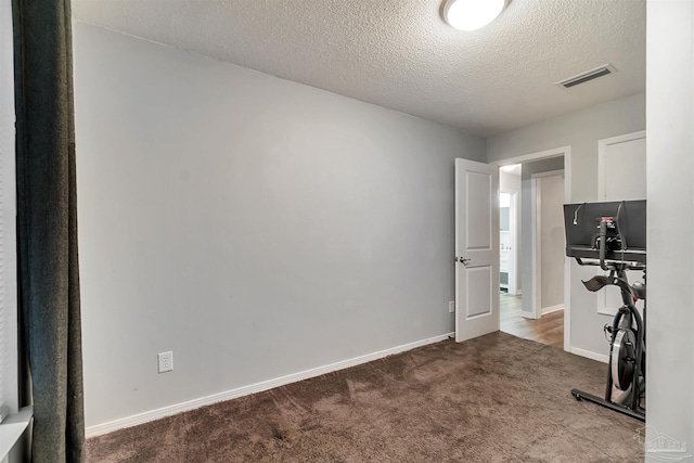 6205 E Forest Pines Dr, Pensacola, FL 32526 - workout area featuring dark colored carpet and a textured ceiling