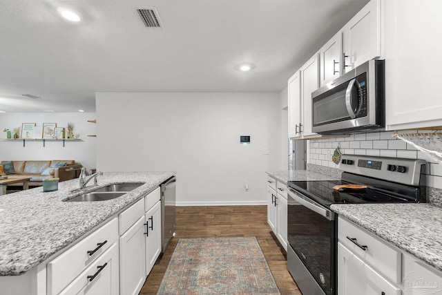 kitchen with dark hardwood / wood-style flooring, white cabinetry, sink, and appliances with stainless steel finishes