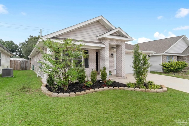 view of front of property featuring central AC unit, a garage, and a front yard