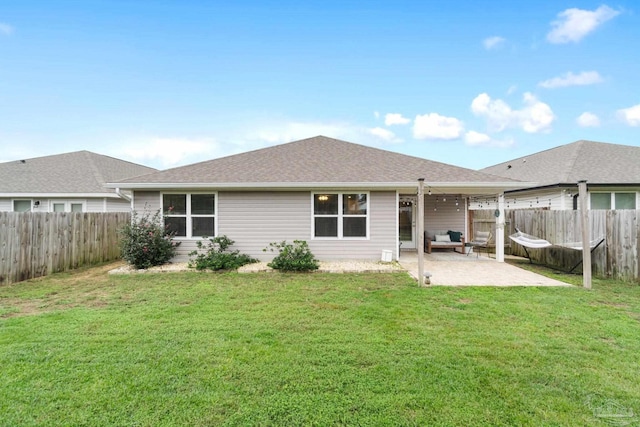 rear view of house with a yard and a patio area