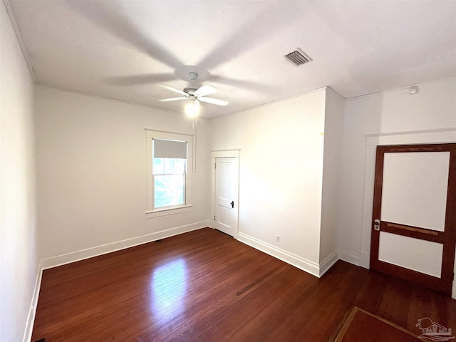 1011 N Reus St, Pensacola, FL 32501 - spare room with visible vents, baseboards, a ceiling fan, and dark wood-style flooring