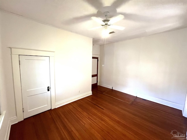 1011 N Reus St, Pensacola, FL 32501 - unfurnished bedroom featuring dark wood finished floors, ceiling fan, and baseboards
