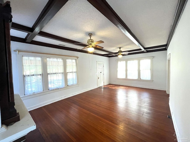 1011 N Reus St, Pensacola, FL 32501 - unfurnished living room featuring beamed ceiling, baseboards, and dark wood-style flooring