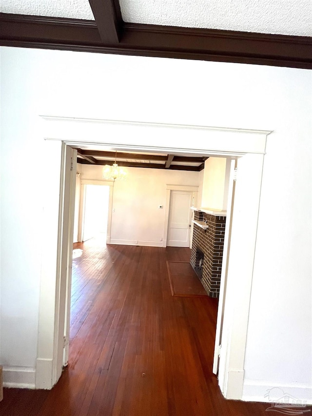 1011 N Reus St, Pensacola, FL 32501 - hall with baseboards, dark wood-type flooring, and beam ceiling