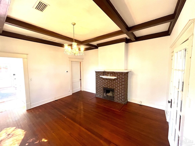 1011 N Reus St, Pensacola, FL 32501 - unfurnished living room with visible vents, a brick fireplace, baseboards, beam ceiling, and hardwood / wood-style flooring