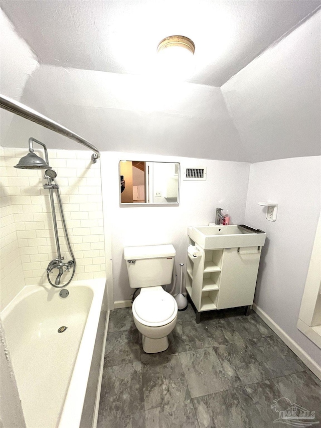 1011 N Reus St, Pensacola, FL 32501 - bathroom featuring visible vents, baseboards, toilet, lofted ceiling, and vanity