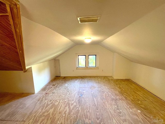1011 N Reus St, Pensacola, FL 32501 - additional living space with visible vents, wood finished floors, and vaulted ceiling