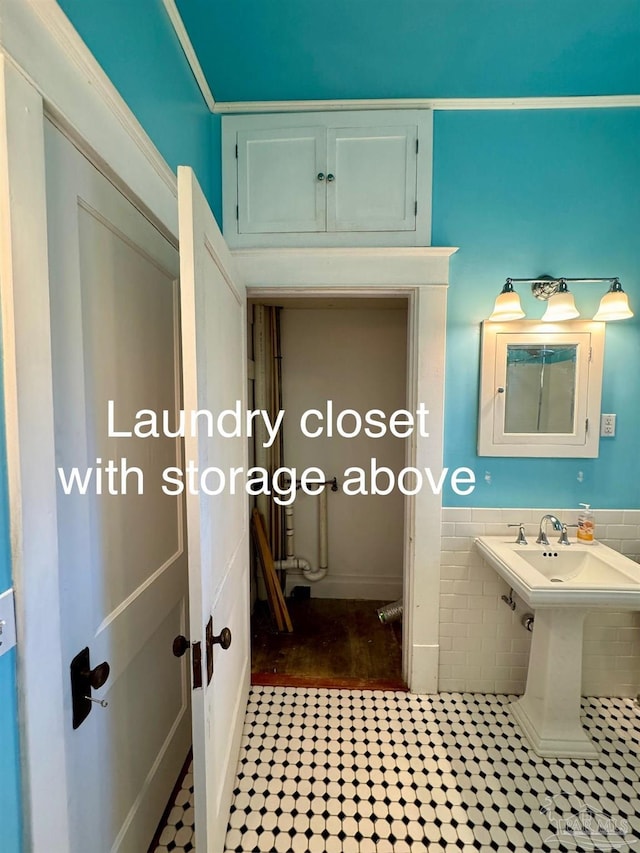 1011 N Reus St, Pensacola, FL 32501 - bathroom with a sink, tile walls, and wainscoting