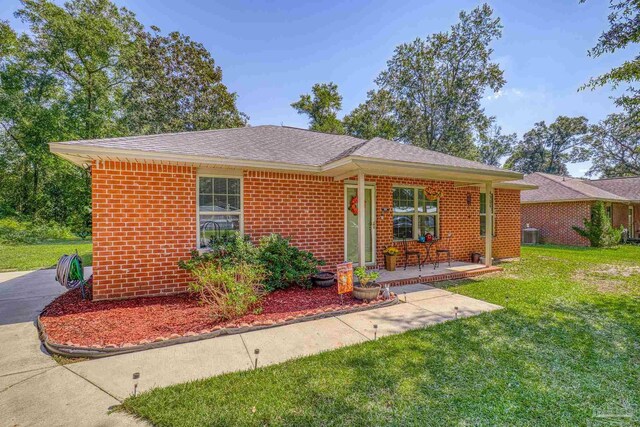 ranch-style home featuring a patio area and a front lawn