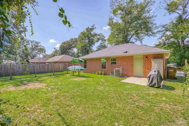 back of property featuring a patio, cooling unit, and a lawn