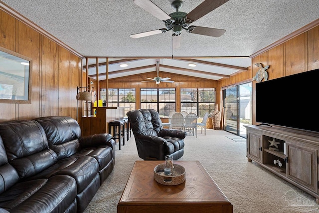 carpeted living room featuring lofted ceiling with beams, a textured ceiling, and wood walls