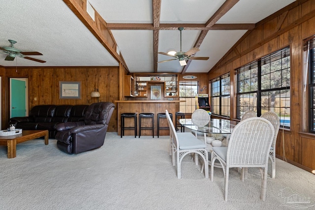 dining space featuring ceiling fan, plenty of natural light, light carpet, and a textured ceiling