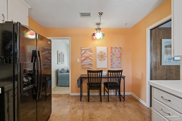 dining room with a textured ceiling