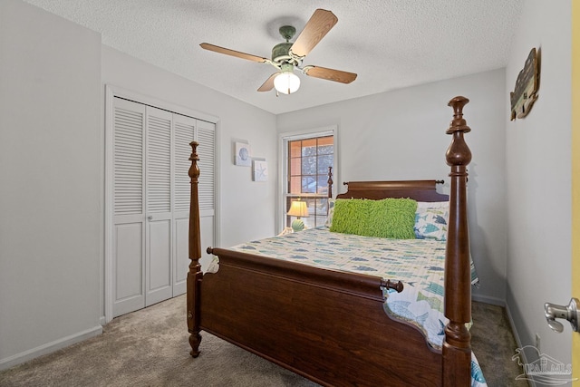 bedroom featuring ceiling fan, light colored carpet, a closet, and a textured ceiling