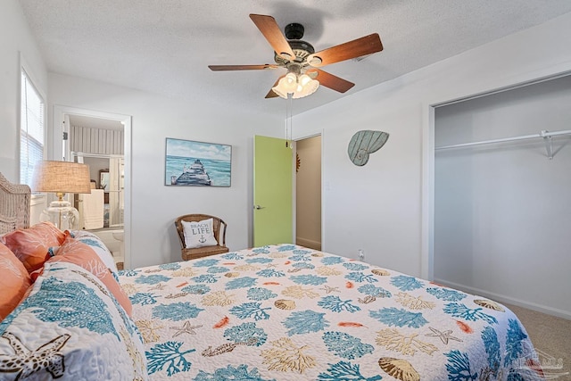 carpeted bedroom featuring a textured ceiling, ceiling fan, and a closet