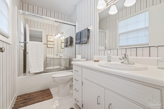 full bathroom with vanity, toilet, enclosed tub / shower combo, and a textured ceiling