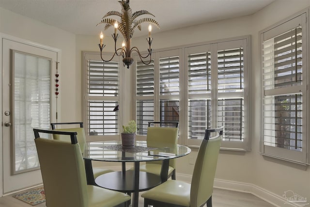 dining area with an inviting chandelier