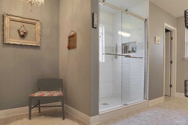 bathroom with a notable chandelier and walk in shower