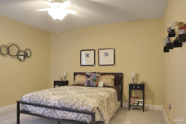 bedroom featuring ceiling fan and light carpet