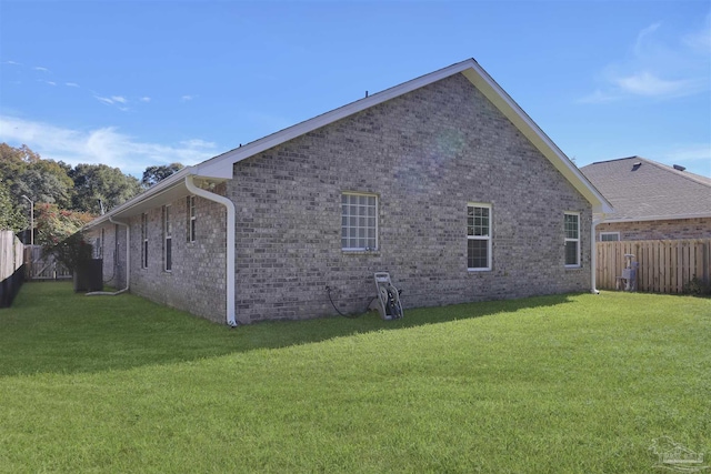 view of side of home featuring a yard