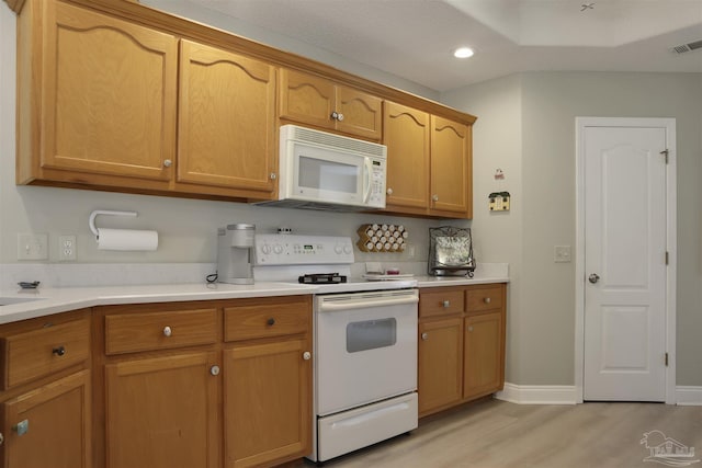 kitchen with white appliances and light wood-type flooring