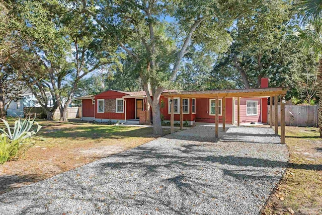 ranch-style home with a carport and a front lawn