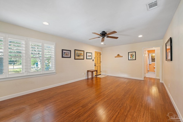 unfurnished room with ceiling fan and hardwood / wood-style floors