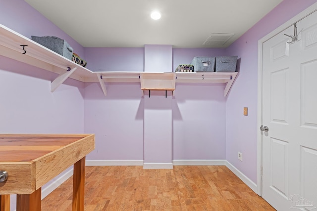 spacious closet with light hardwood / wood-style floors