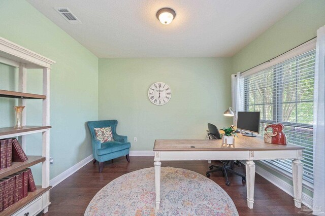 home office featuring baseboards, visible vents, and wood finished floors