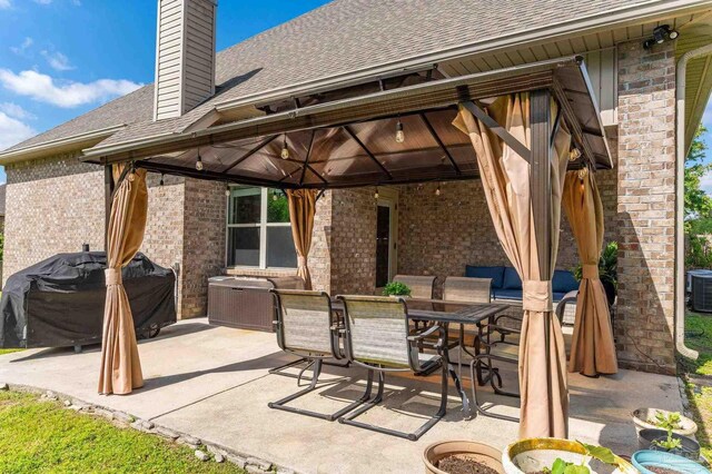 view of patio with a gazebo, cooling unit, outdoor dining space, and a grill