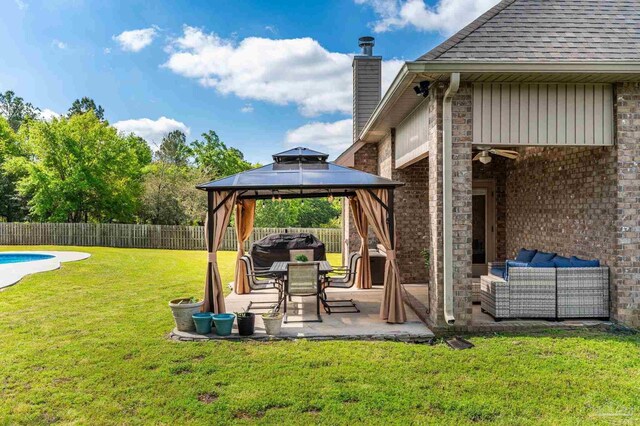 view of yard featuring a patio, a fenced backyard, an outdoor hangout area, a fenced in pool, and a gazebo