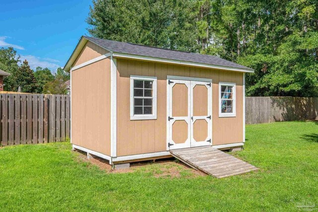 view of shed with a fenced backyard