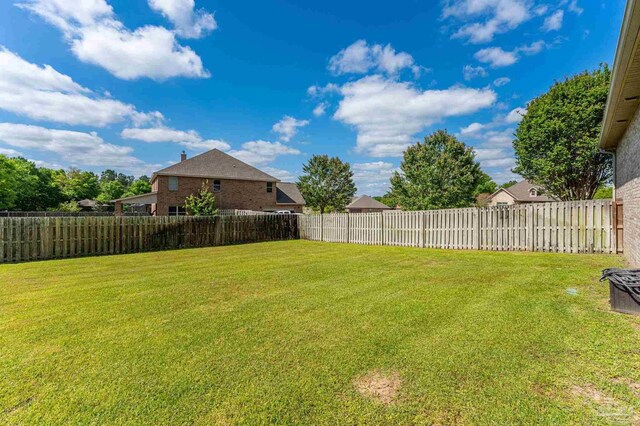 view of yard with a fenced backyard