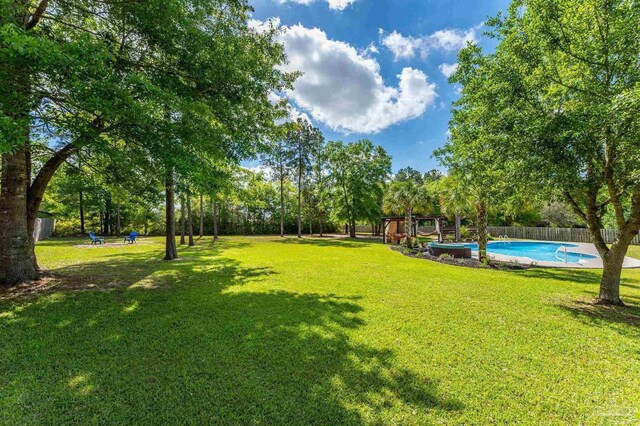view of yard with a fenced in pool and a fenced backyard