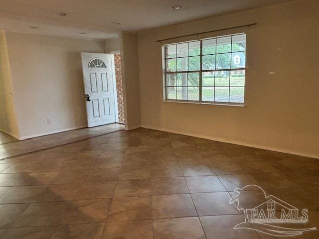 unfurnished room featuring tile patterned floors